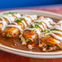 Enchiladas Poblanos Platter · Choices beef or chicken. Four enchiladas topped with mole poblano sauce, lettuce, tomatoes, ...