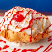 Fried Ice Cream · Vanilla ice cream in a crispy tortilla shell topped with whipped cream, honey, chocolate cin...