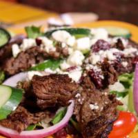 Steak Ensalada · Grilled marinated steak on top of mixed greens with garden fresh tomatoes, cucumbers, dried ...