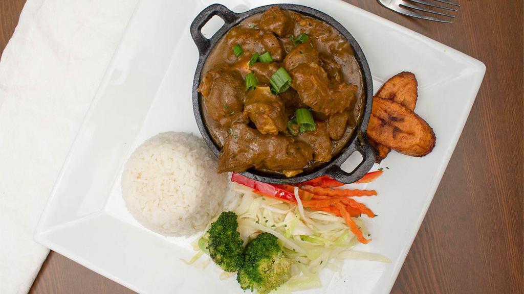 Curry Goat · Bone-in goat meat in curry spices.