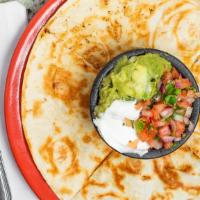 Quesadilla Ranchera · Two 10 inch flour tortillas stuffed with grilled chicken or steak, refried beans and cheese....