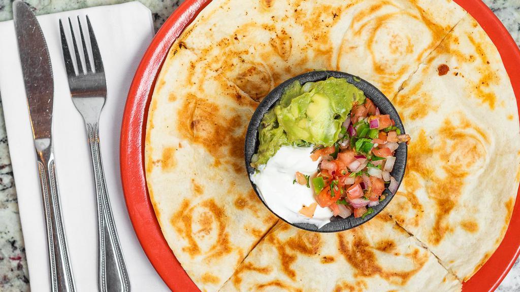 Quesadilla Ranchera · Two 10 inch flour tortillas stuffed with grilled chicken or steak, refried beans and cheese. Served with Pico de Gallo, sour cream and guacamole.