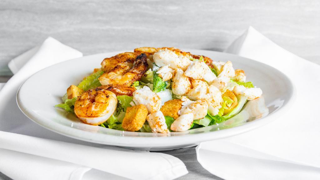 Under The Boardwalk Caesar Salad · Romaine lettuce lump crab meat grilled shrimp broiled scallops parmesan and croutons tossed in creamy caesar dressing.