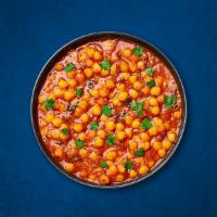 Spicy Garbanzo Curry (Vegan) · Chickpea cooked with sauteed onion, tomato, ginger, and garlic with Indian herbs and spices