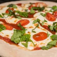 Margherita Pizza · Pizza sauce, fresh mozzarella cheese, fresh tomatoes and basil.