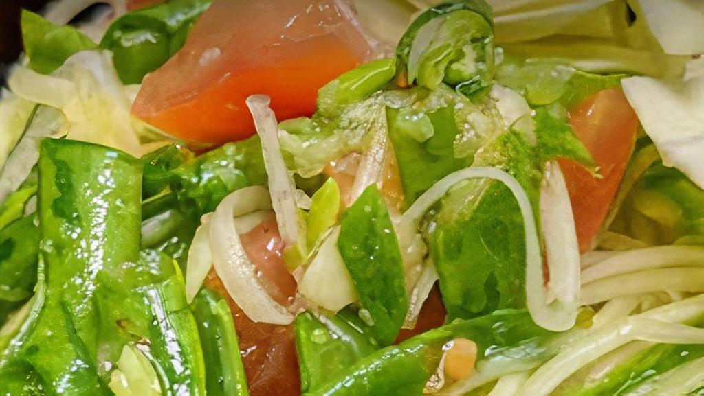 Papaya Salad (Som Tum) · Green papaya, peanut, carrot, string bean, tomatoes in tasty chili and lime sauce.