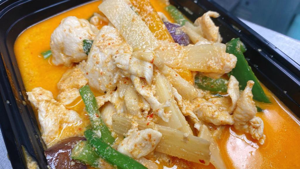Red Curry · Hot. Cooked with bamboo shoots, string-bean, eggplant, pepper and fresh basil leaves in coconut red curry.