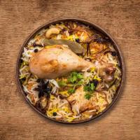 Yum Chicken Dum Biryani · Long grain basmati rice cooked with tender chicken and aromatic Indian herbs.
