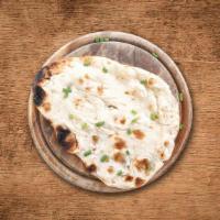 Naan Bread · White flour flatbread baked to perfection in a traditional Indian clay oven.
