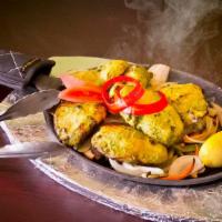 Basil Chicken Tikka Kabab · Boneless chicken cubes marinated with fresh basil, ginger, garlic cooked in a clay oven.
