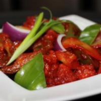 Chili Chicken · Batter fried cubes cooked with onions and bell peppers in a chef's special Indo-Chinese sauce.