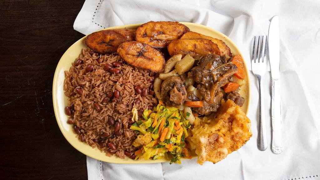 Oxtails · Fall-off-the-bone tender oxtails served with rice and peas/ or white rice, cabbage, and plantains