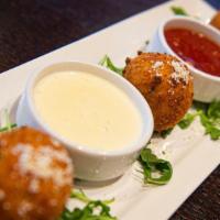 Arancini · Flash-fried rice balls with ground beef, peas, fontina cheese, duo dipping sauce