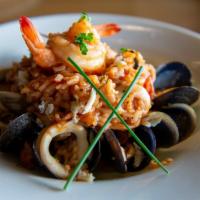 Risotto Pescatore · Clams, mussels, calamari, shrimp, crab meat, organic cherry tomatoes, white wine flambee