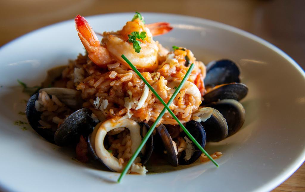 Risotto Pescatore · Clams, mussels, calamari, shrimp, crab meat, organic cherry tomatoes, white wine flambee