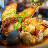 Cacciuco Tuscan Seafood Stew · Gulf shrimp, mussels, clams, calamari, sea scallops, lobster tail, catch of the day, white w...